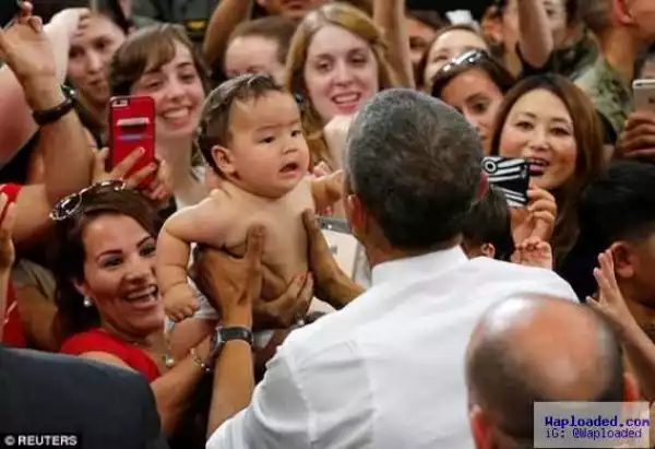 Photos: President Obama calms a crying baby in Japan 